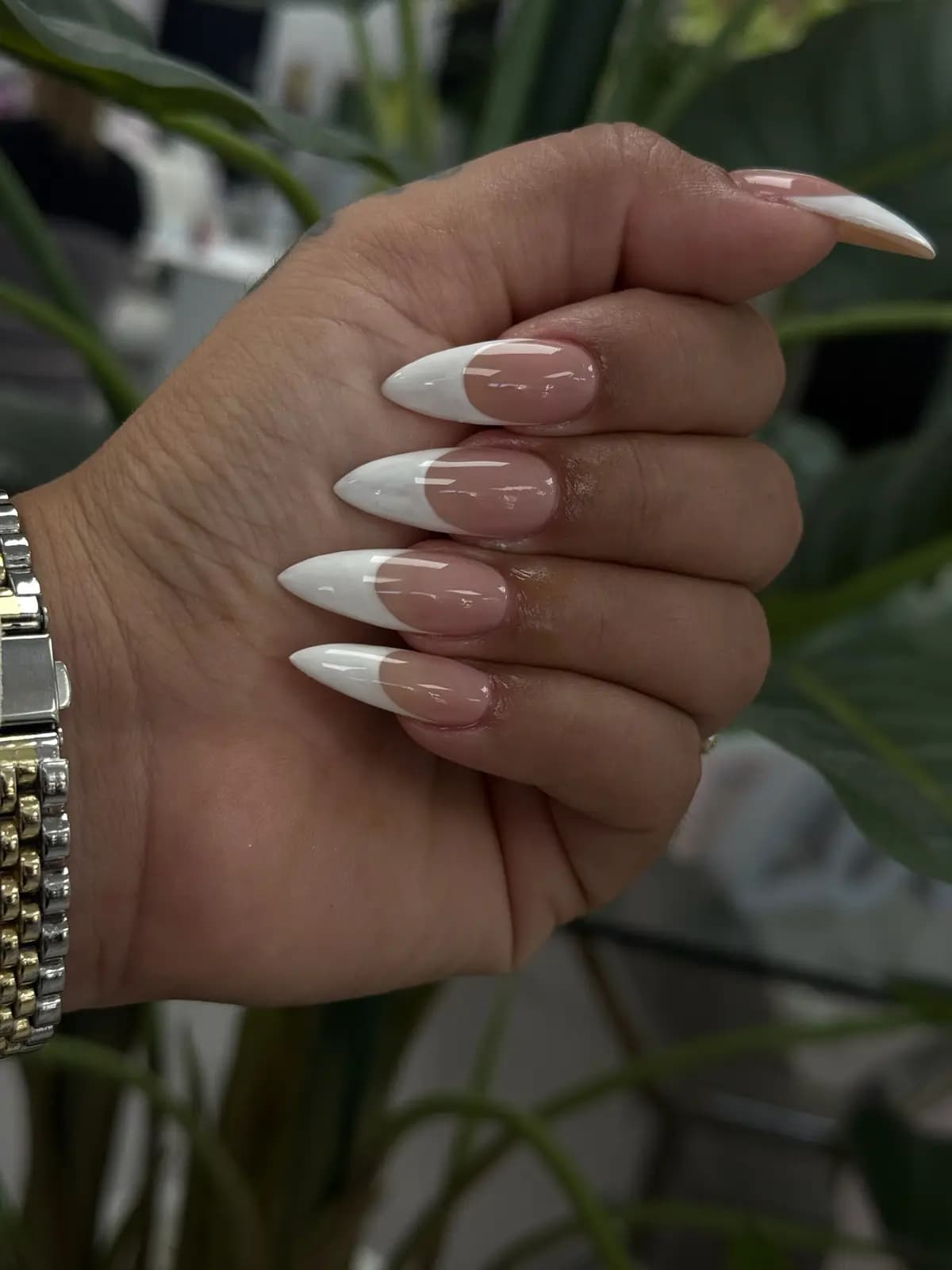 Classic white french tips on medium-length almond nails