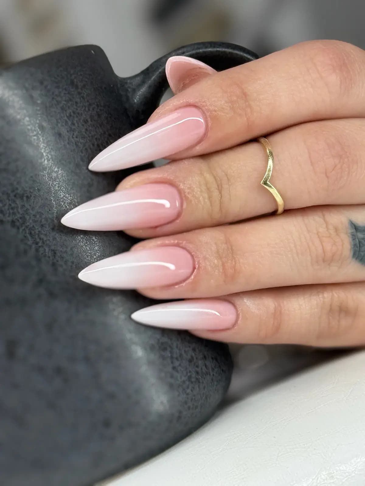 Pink-and-white baby boomer fade on long stiletto nails