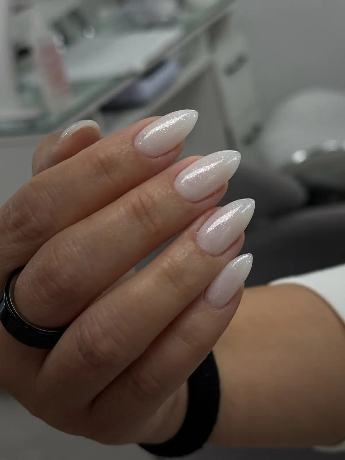 Short almond nails in milky nude gel, clean finish with no art