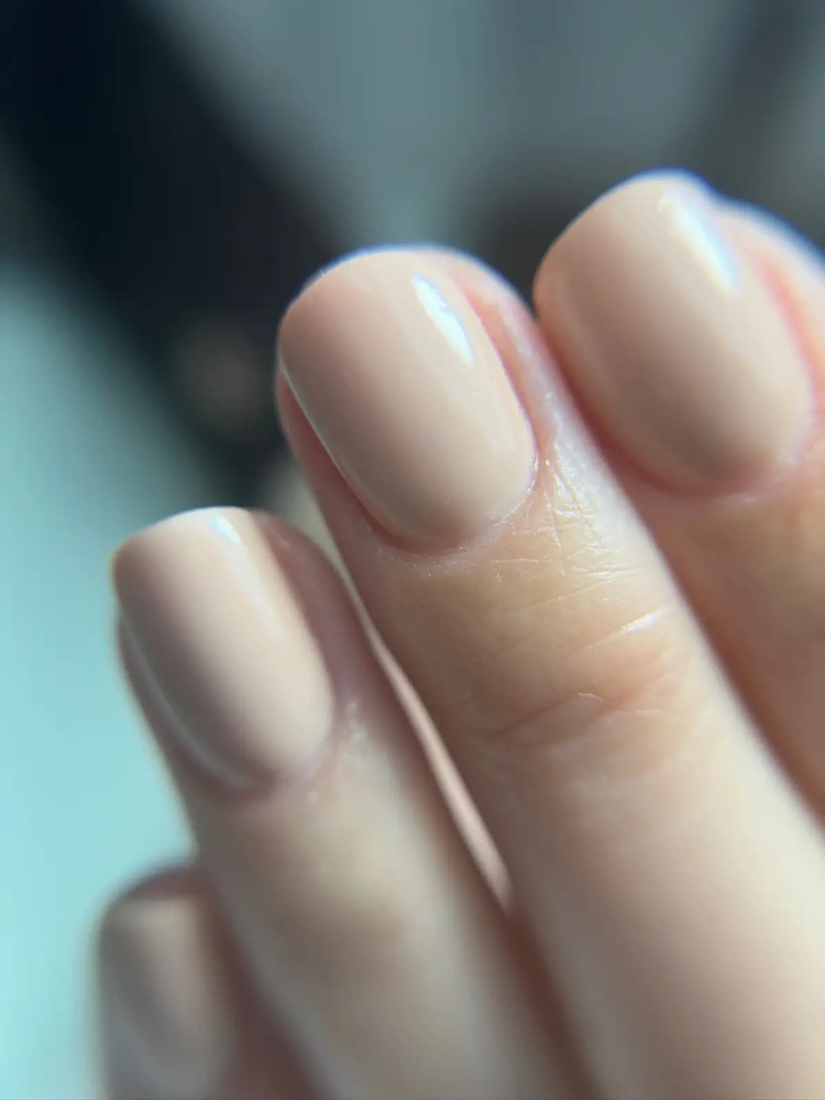 Short natural nails with sheer nude polish and worked cuticles