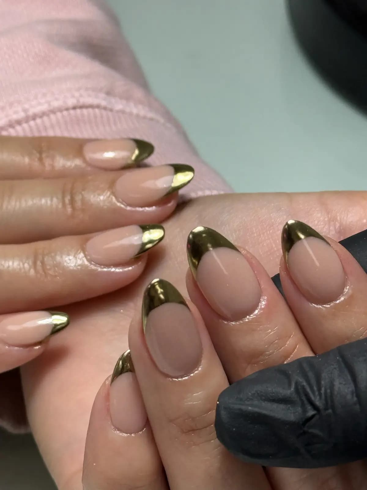 Gold chrome french tips over nude almond nails