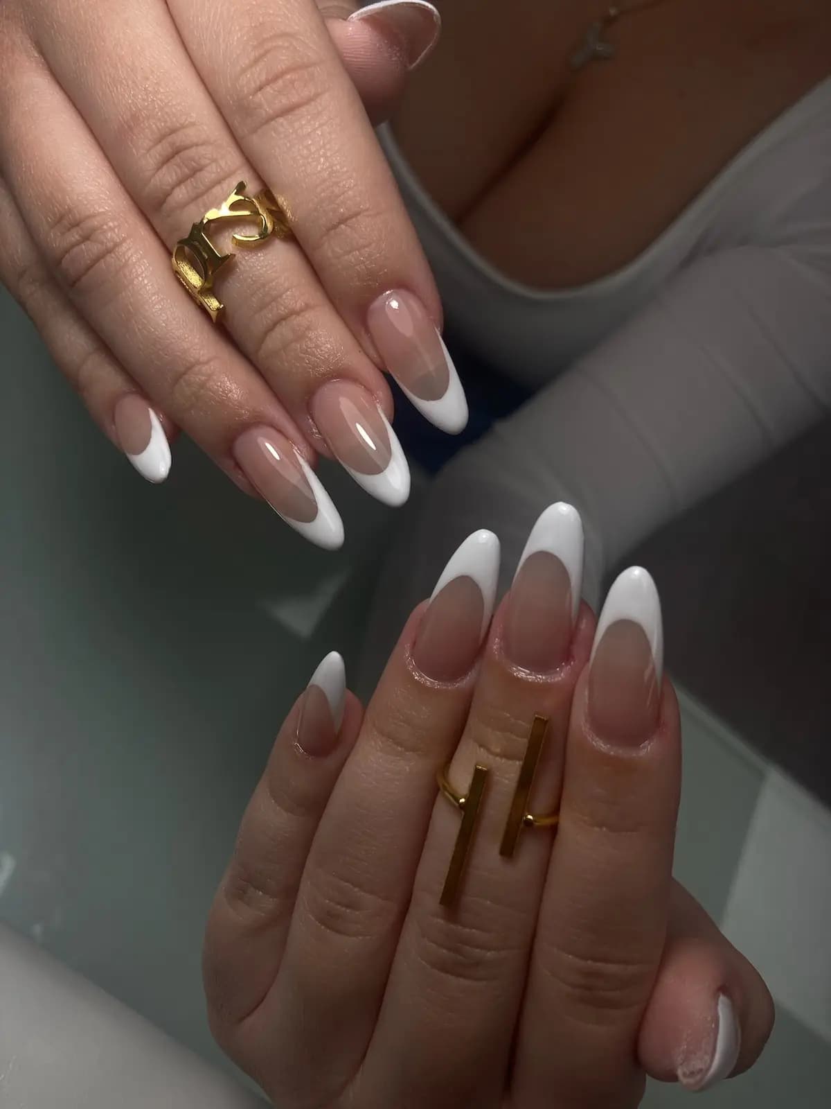 White french on long almond nails, both hands