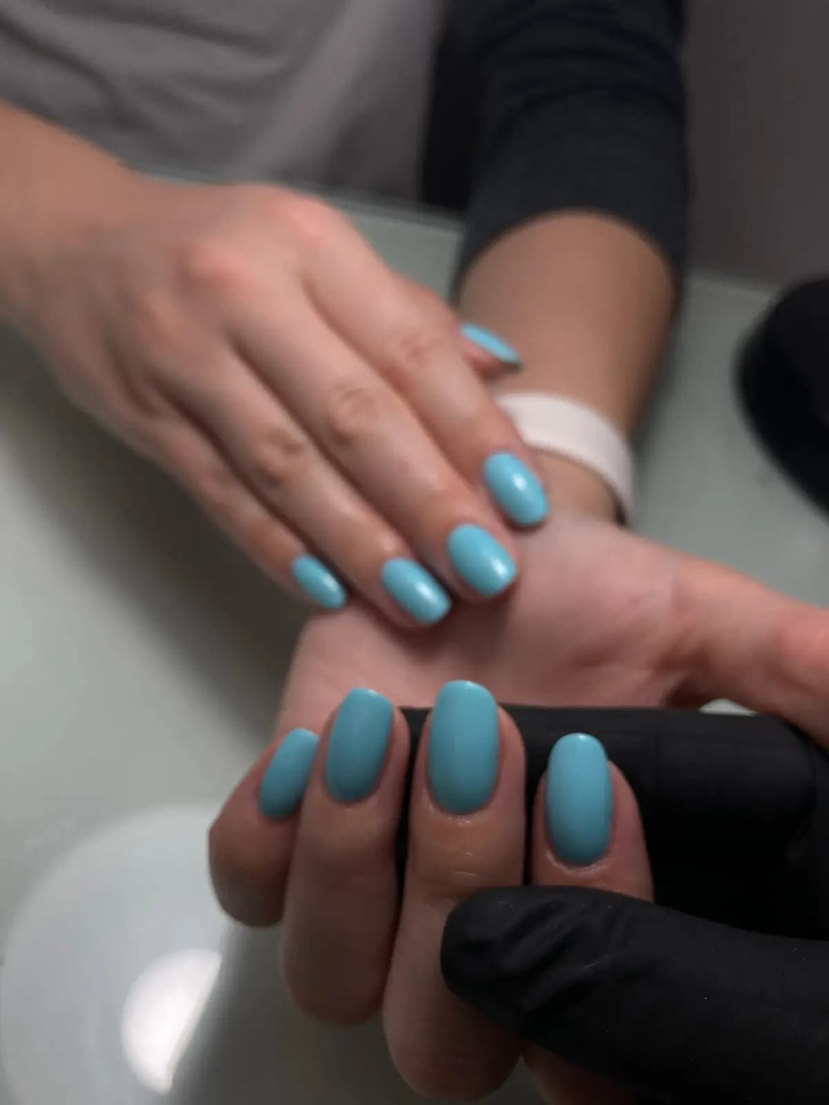 Sky blue gel on square nails, done at the manicure station