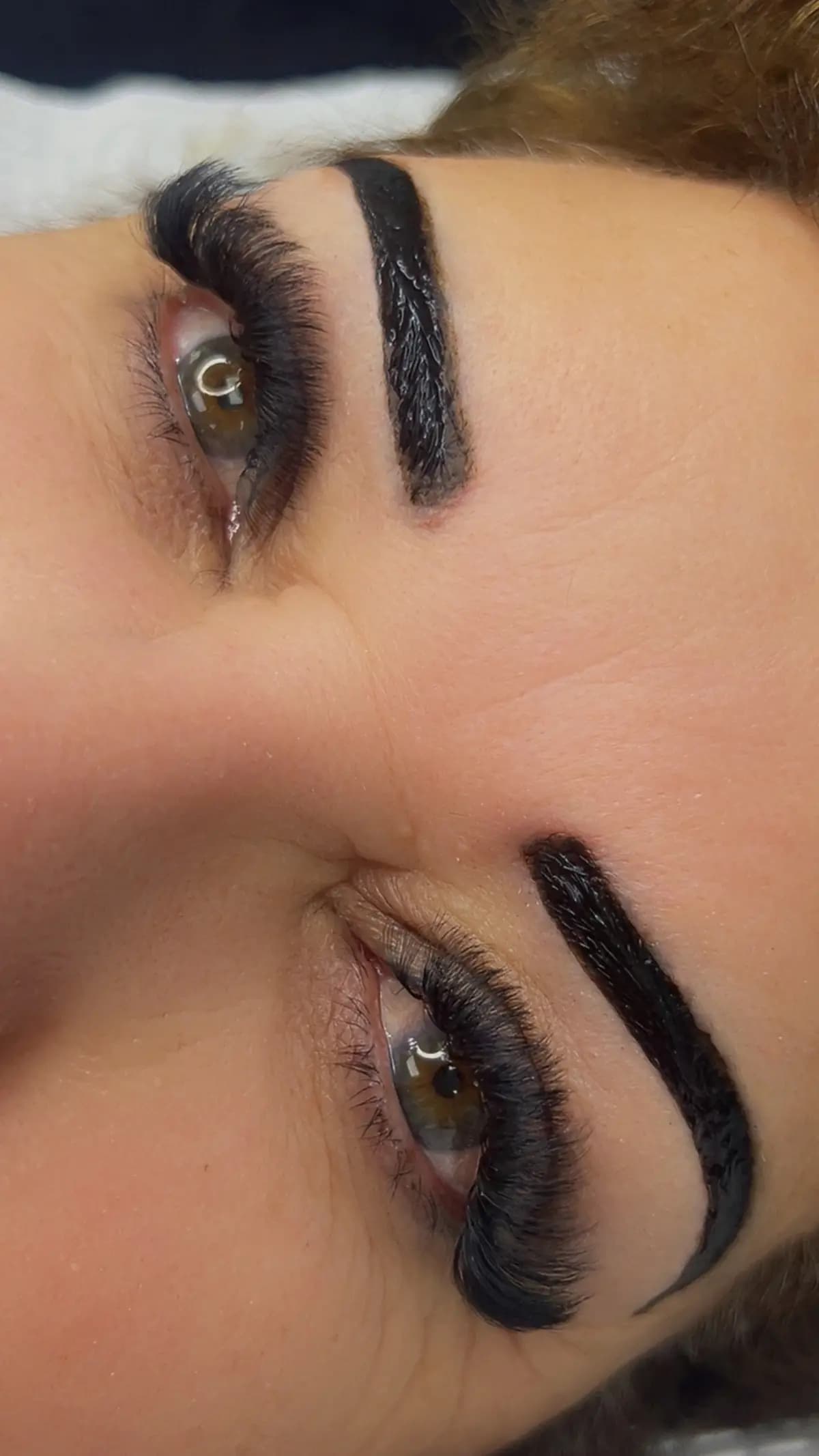 Closed eye with a dramatic volume set and a defined brow