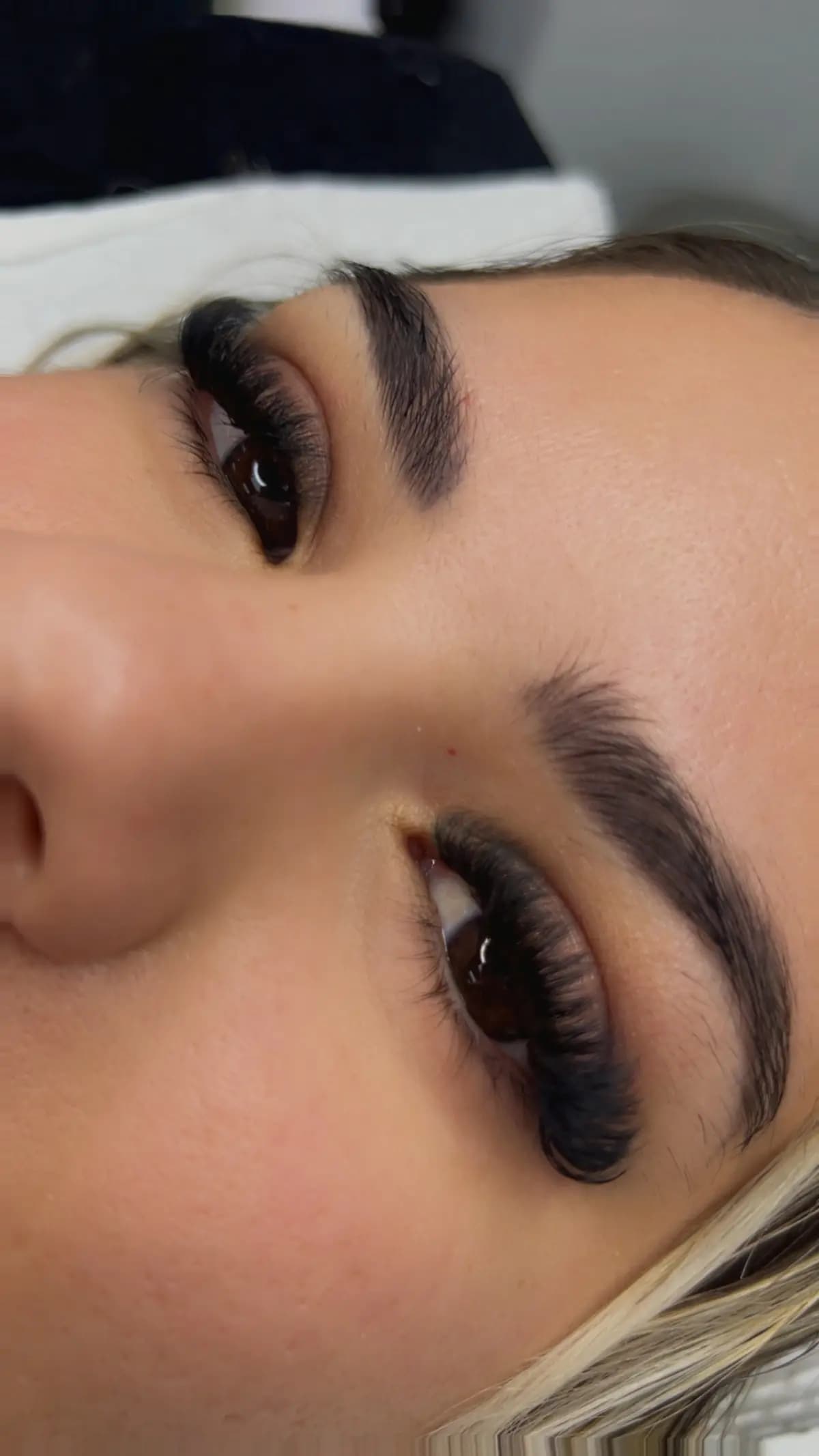 Closed eye in profile with lashes applied one by one