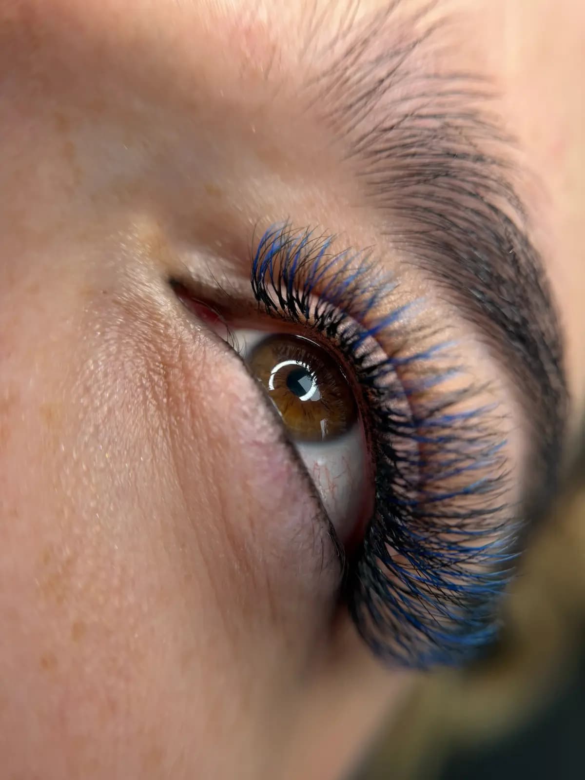 Close up of volume eyelash extensions with dense fans and a strong curl