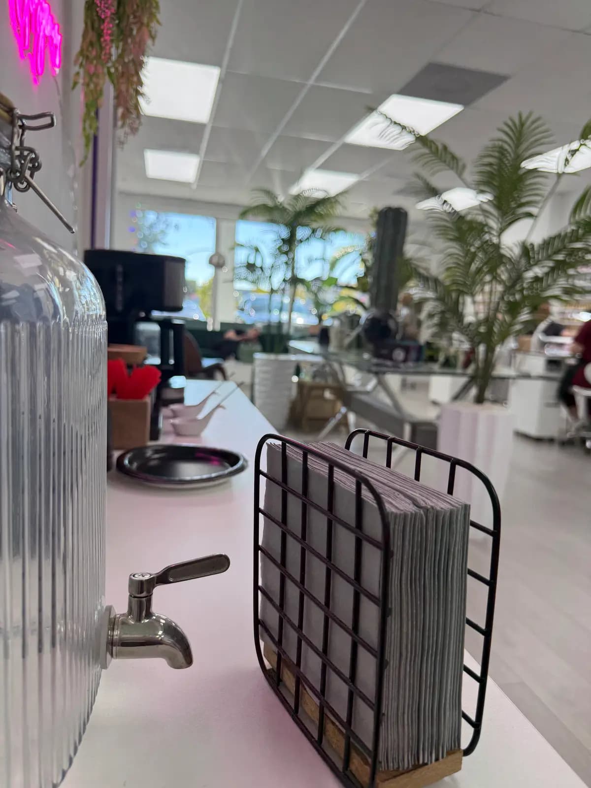 Wide view of the salon from the entrance, windows at the back