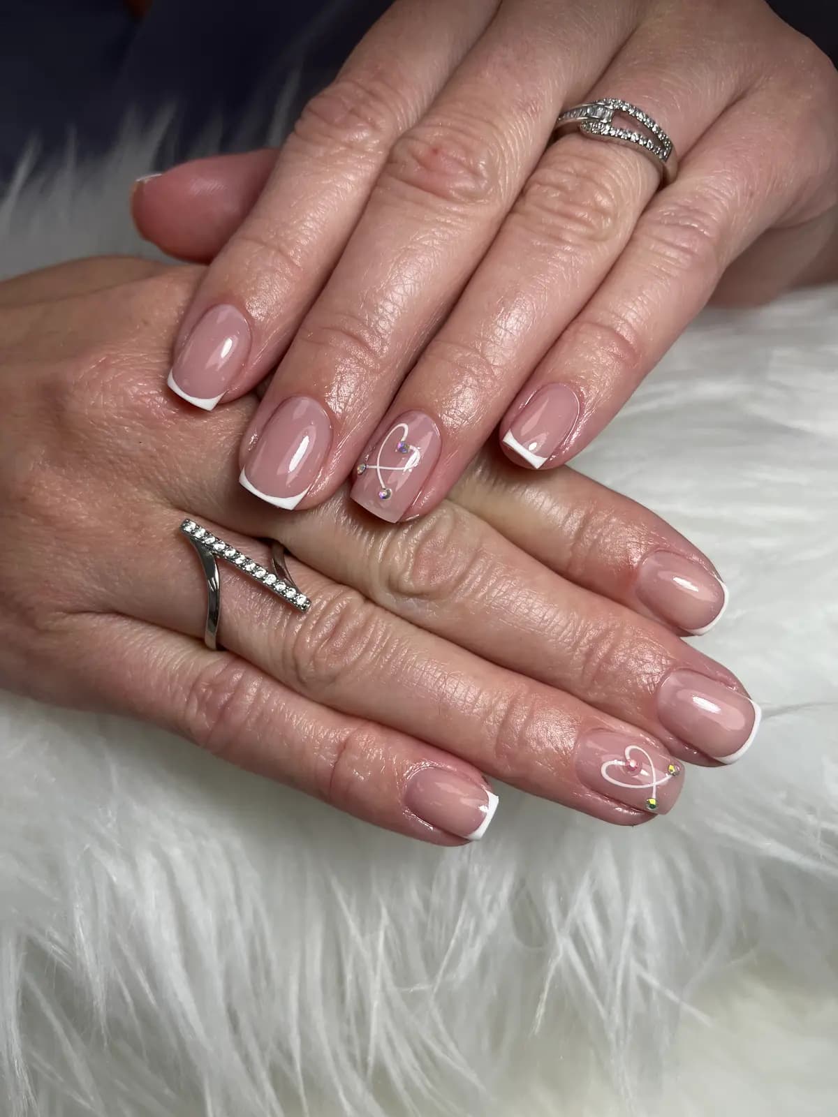 Nude nails with very fine gold strokes, a quiet finish
