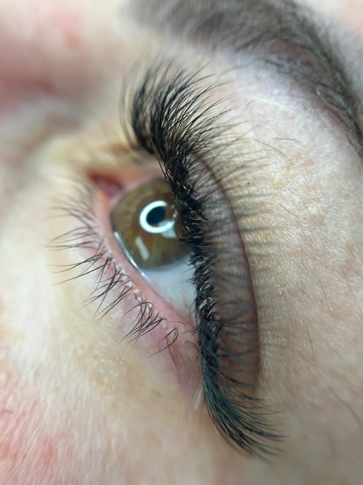 Closed eye with lashes applied one by one, no visible glue