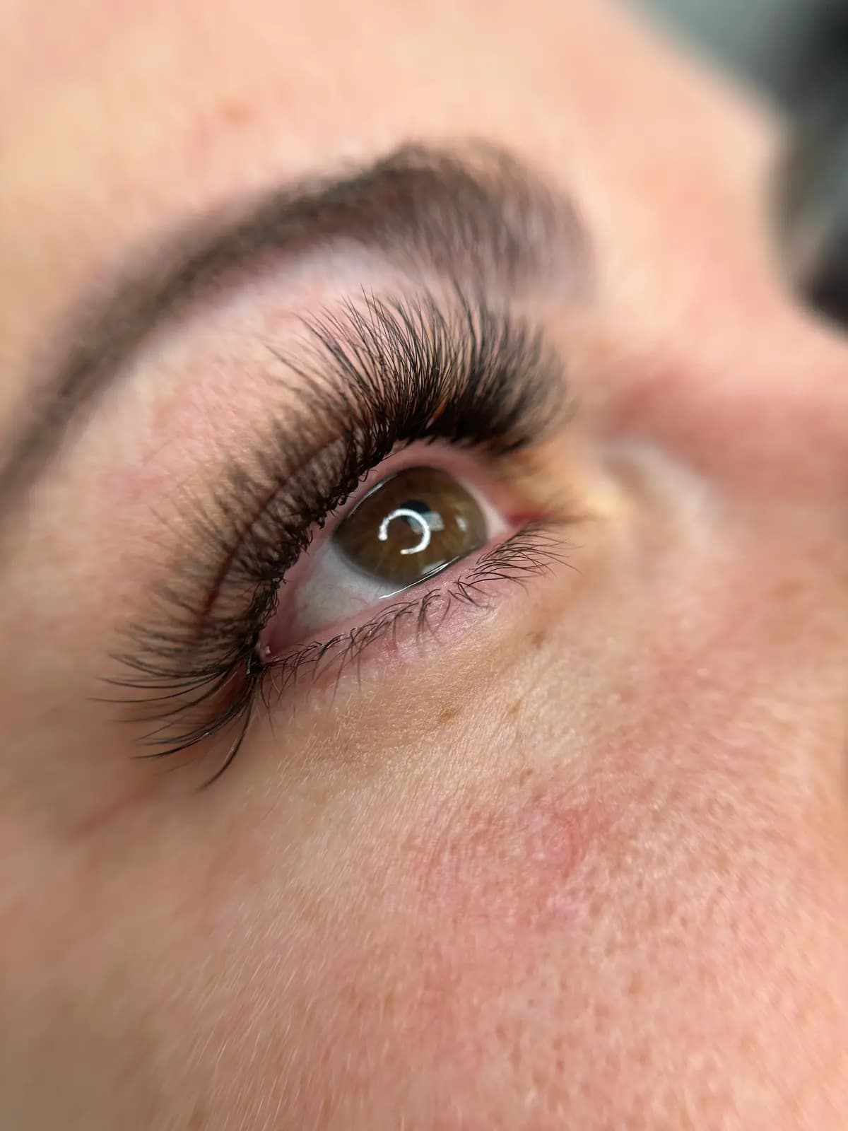 Hybrid extensions with a defined brow, open gaze