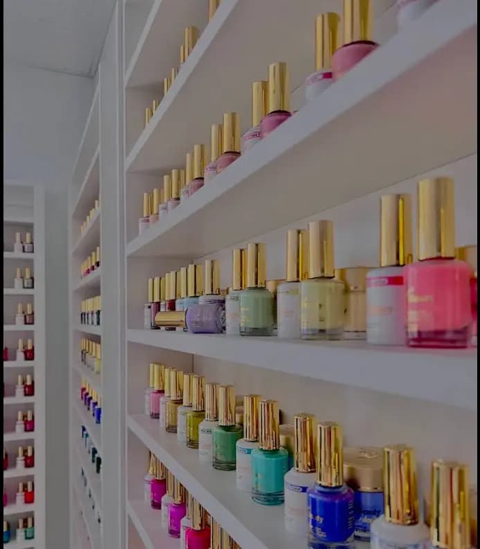 Shelving with polishes and treatment products arranged by colour