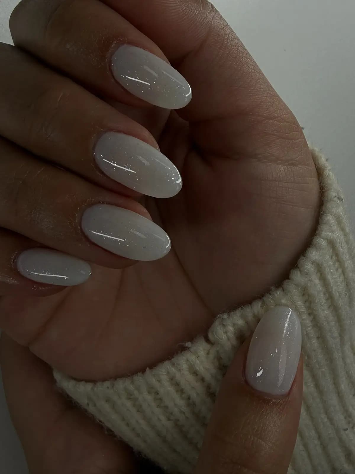 Almond nails in milky white gel with a natural finish and soft shine