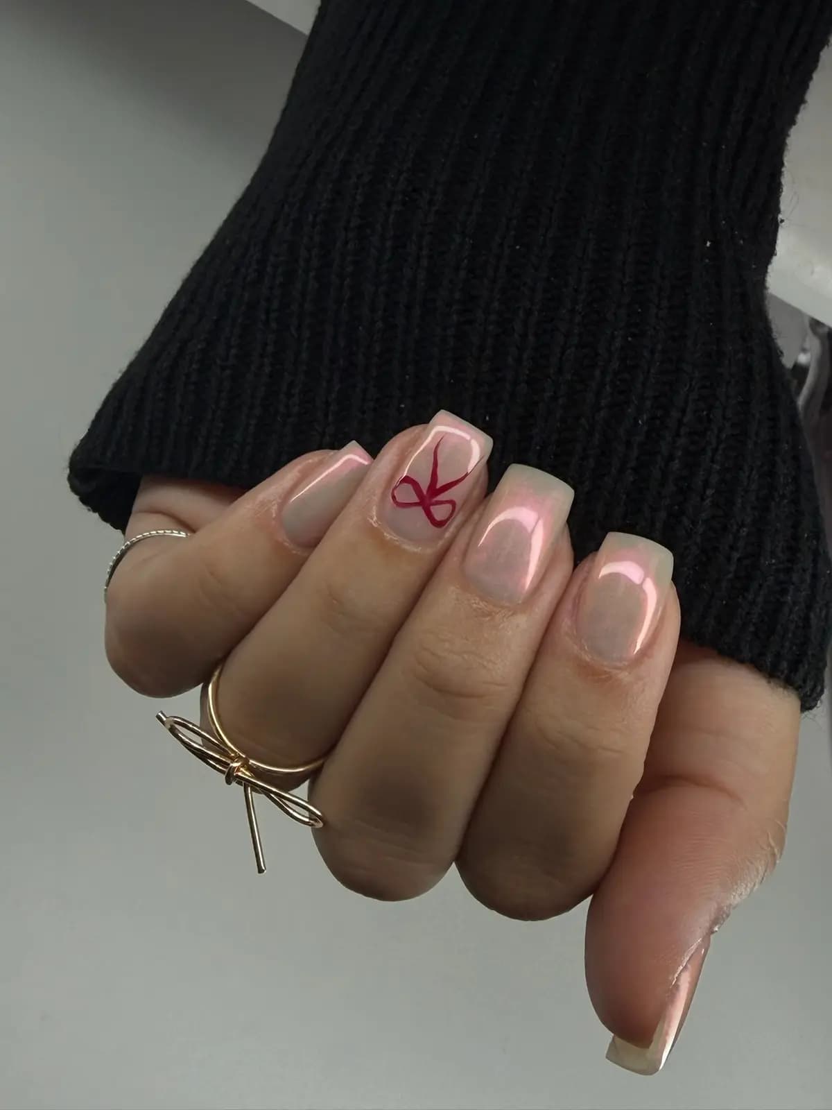 Nude french with a red bow on the accent nail, square shape