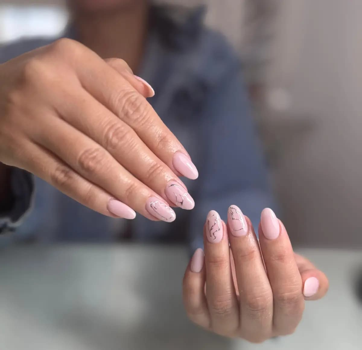 Hands with a natural nude manicure and tidy cuticles, no colour