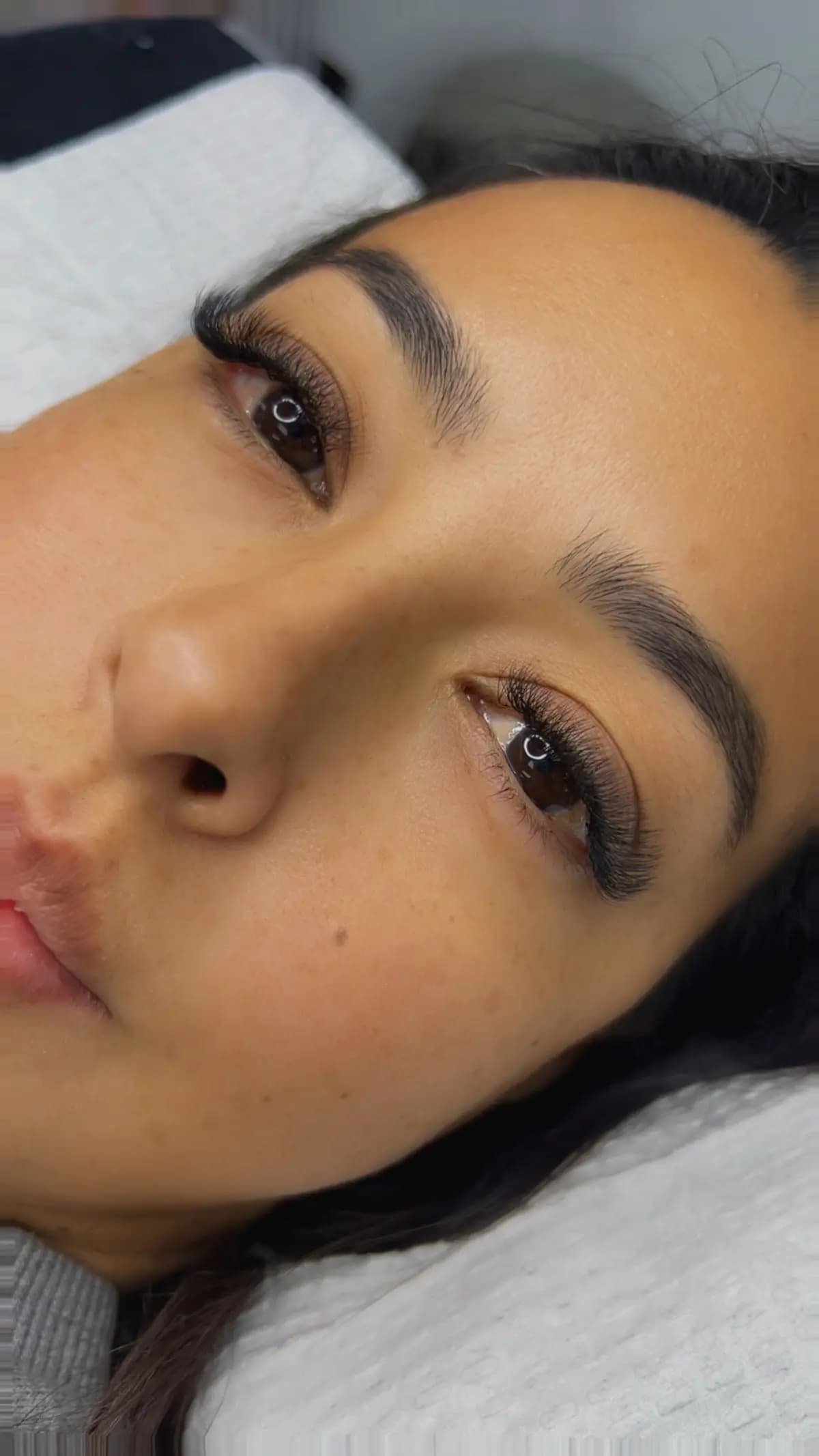 Shaped brow alongside lash extensions, same client