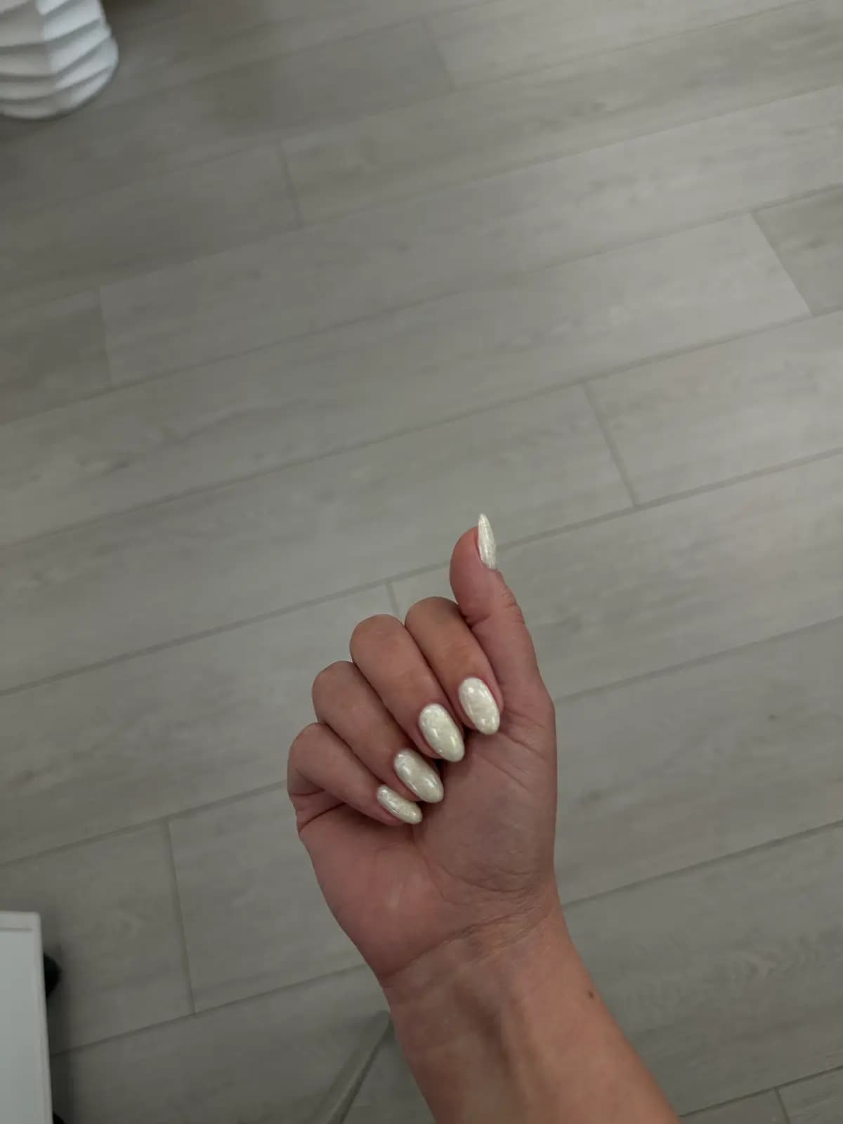 Almond nails in nacre white gel under natural light