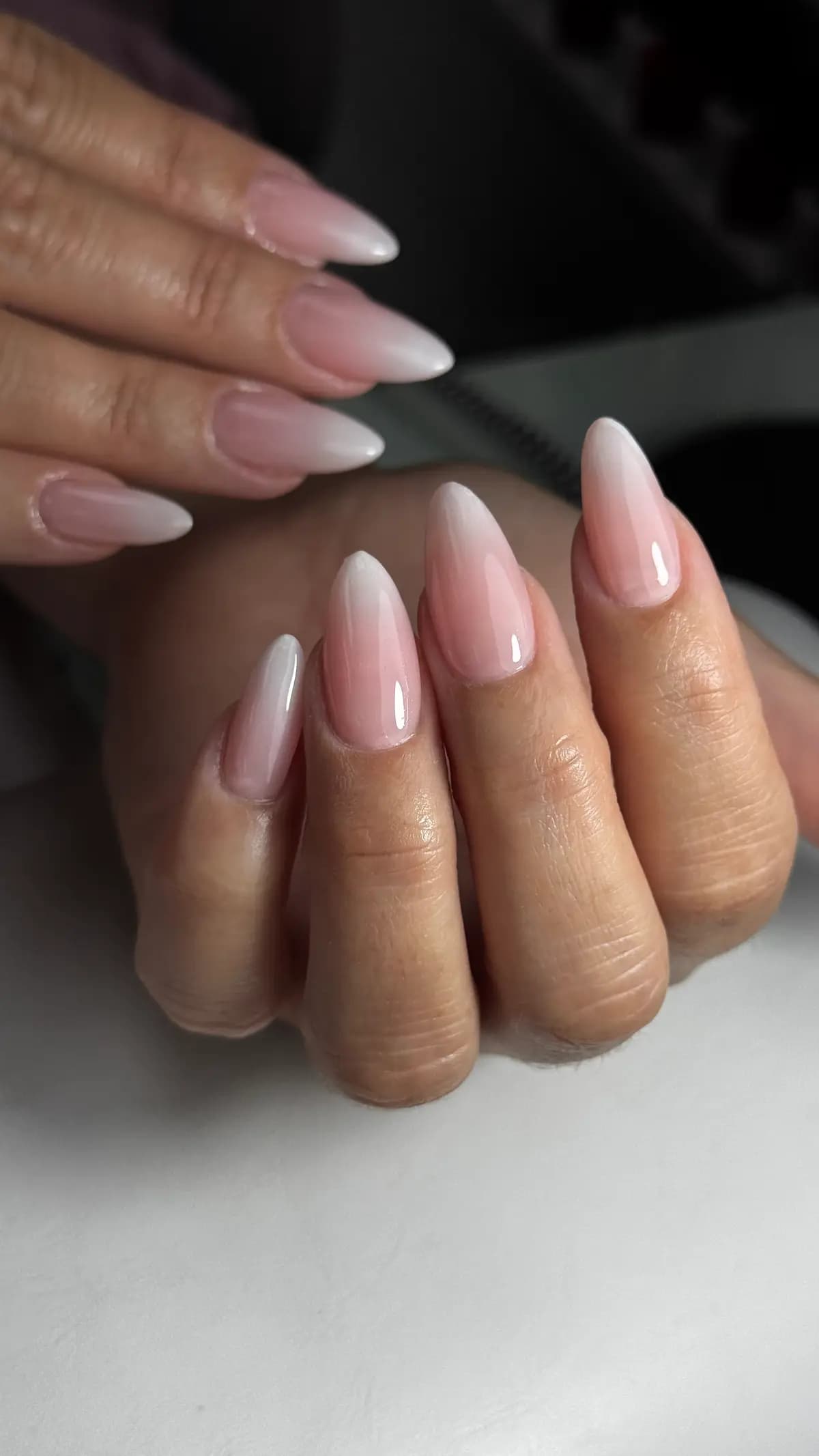 Pink-and-white baby boomer on almond nails, both hands