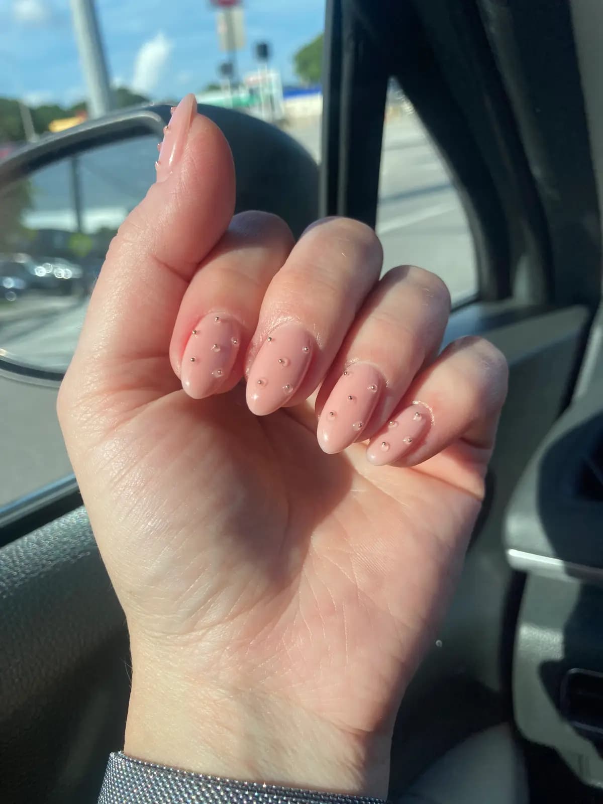Short natural nails with a nude finish and an oval filed edge
