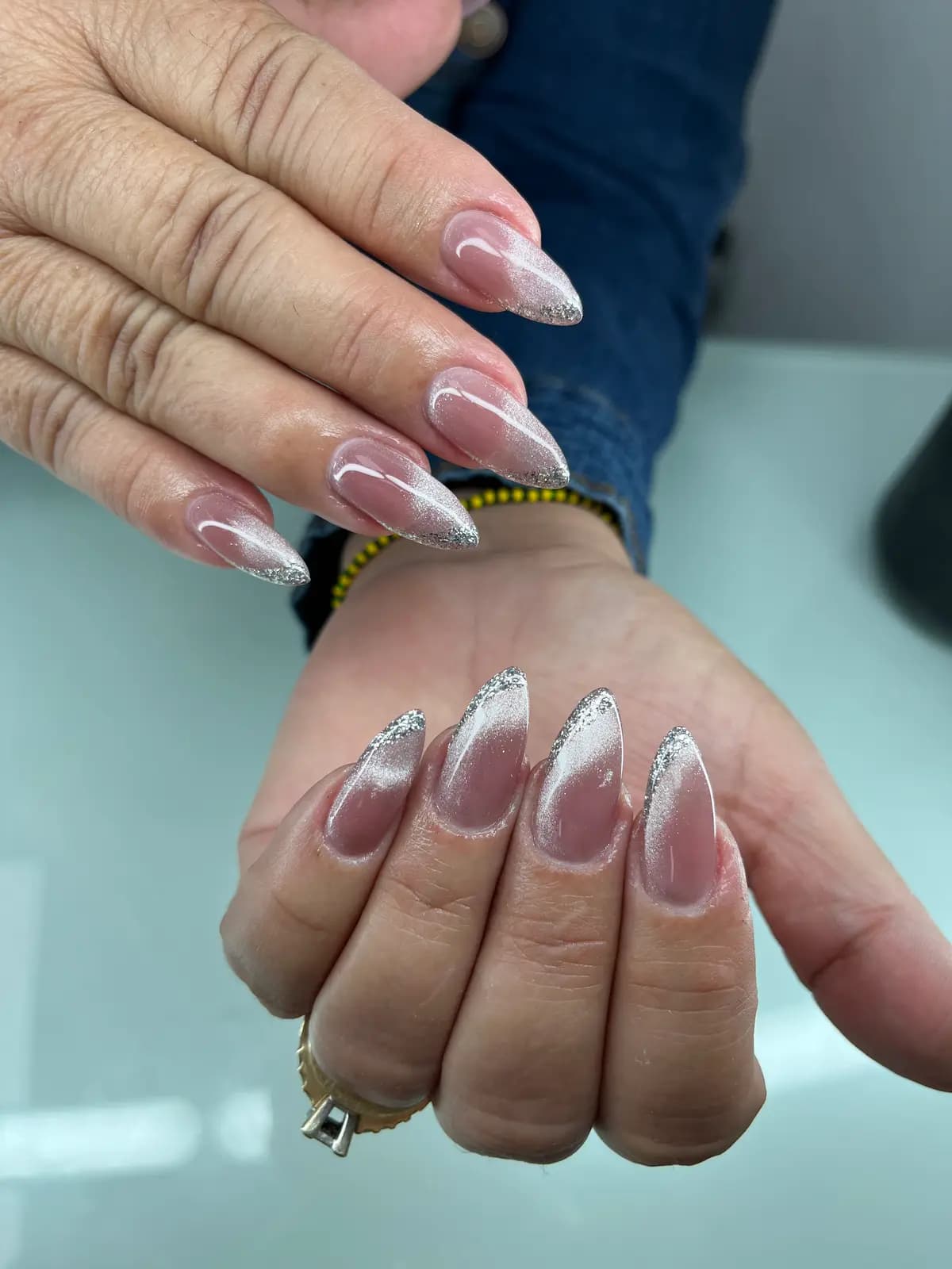 Silver glitter french on long almond nails