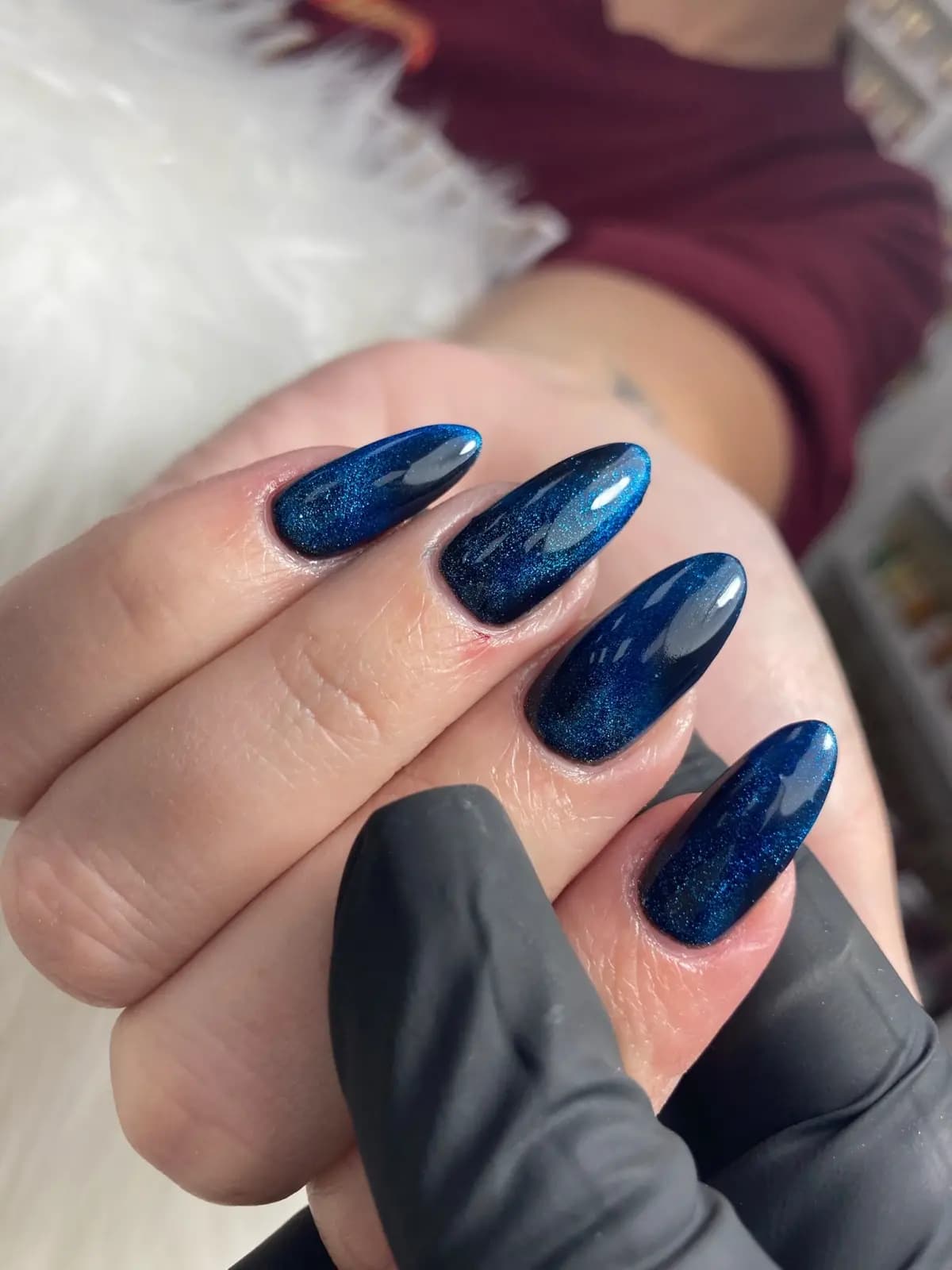 Almond-shaped navy blue gel nails with shimmer and a mirror finish, done at Live Love Beauty Salon in Hialeah, FL