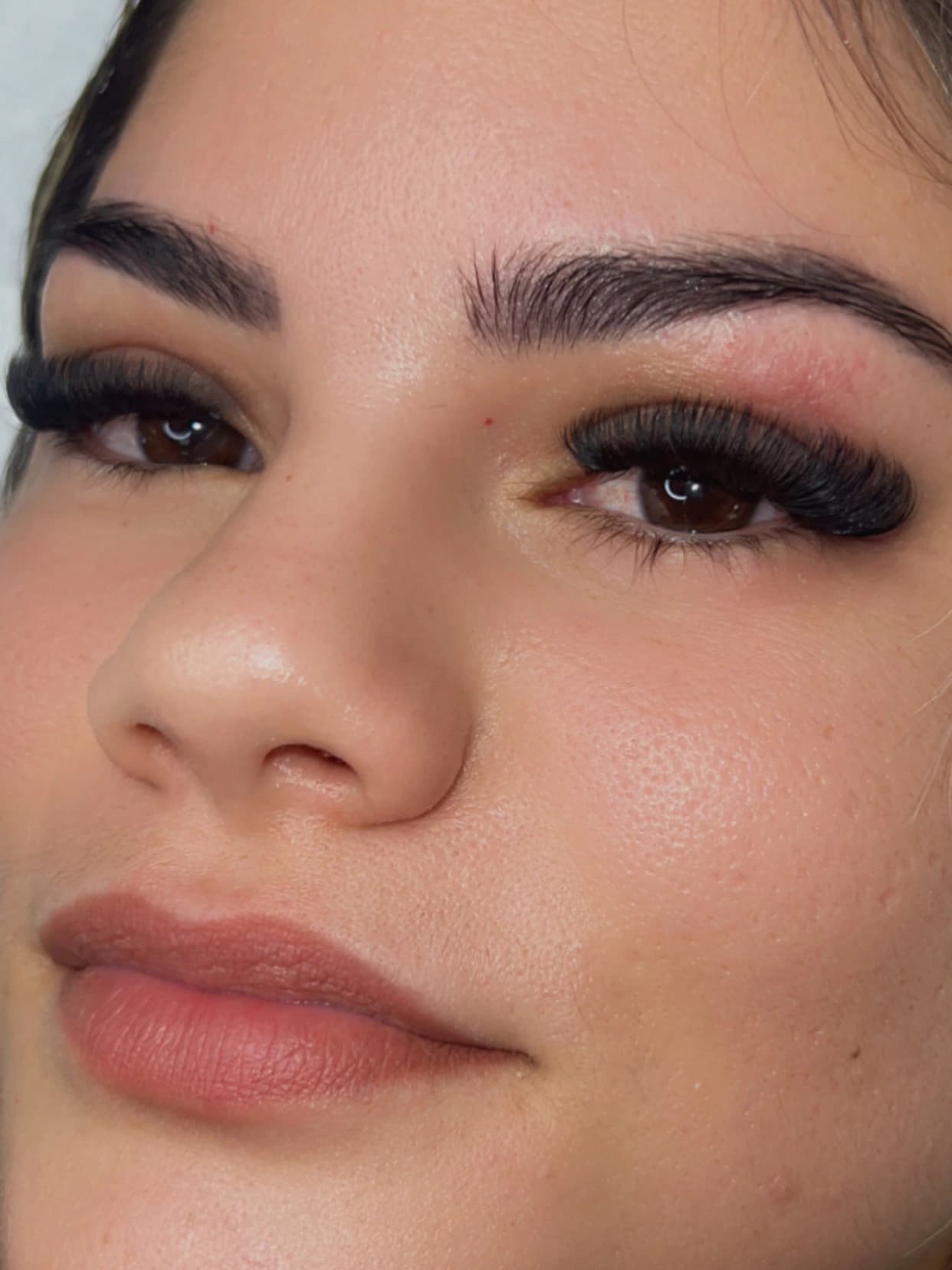 Volume eyelash extensions with dense fans and a strong curl, alongside defined brows, in Hialeah, FL