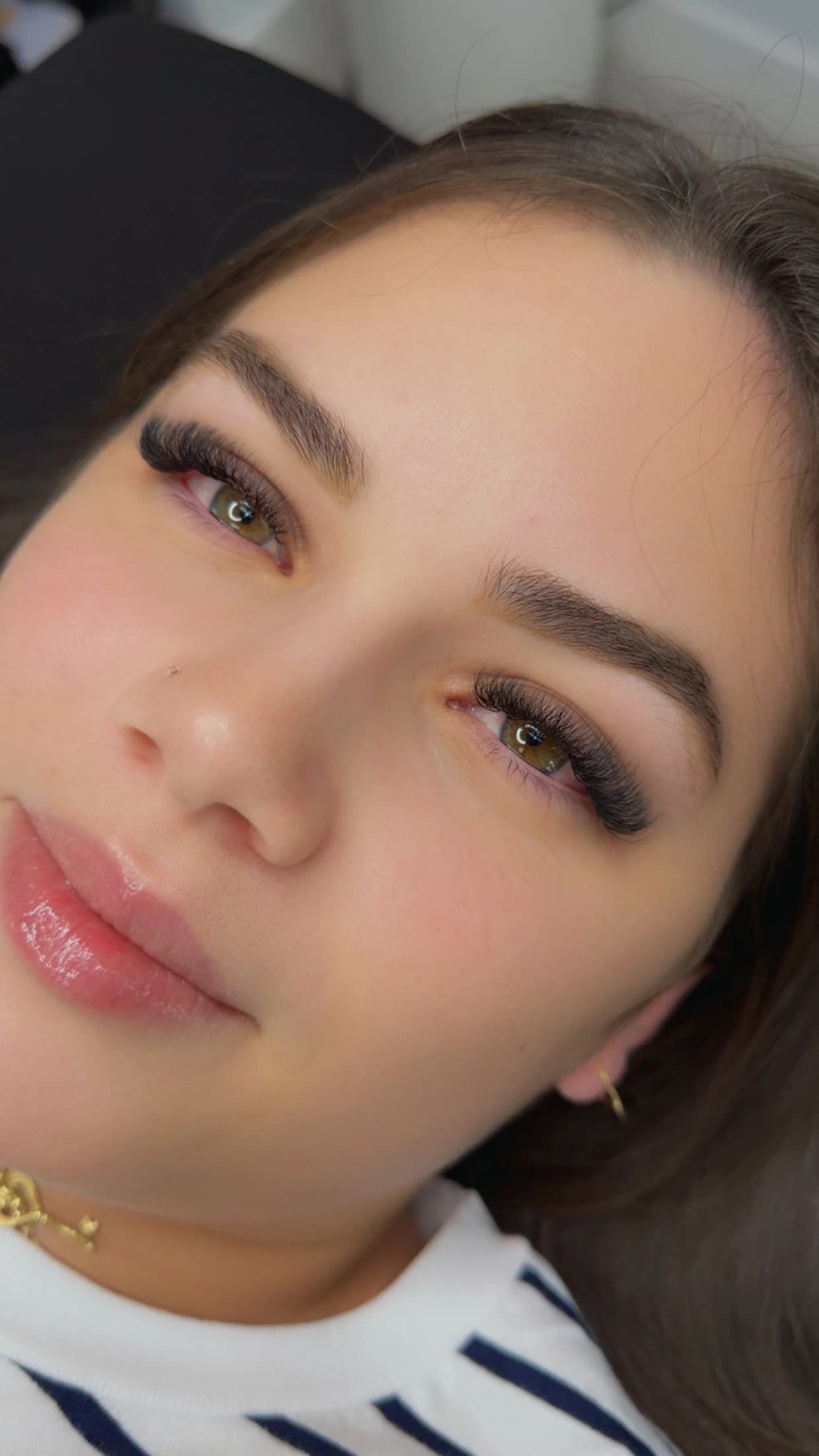 Natural-looking hybrid eyelash extensions on hazel eyes, with brushed and defined brows, Hialeah FL