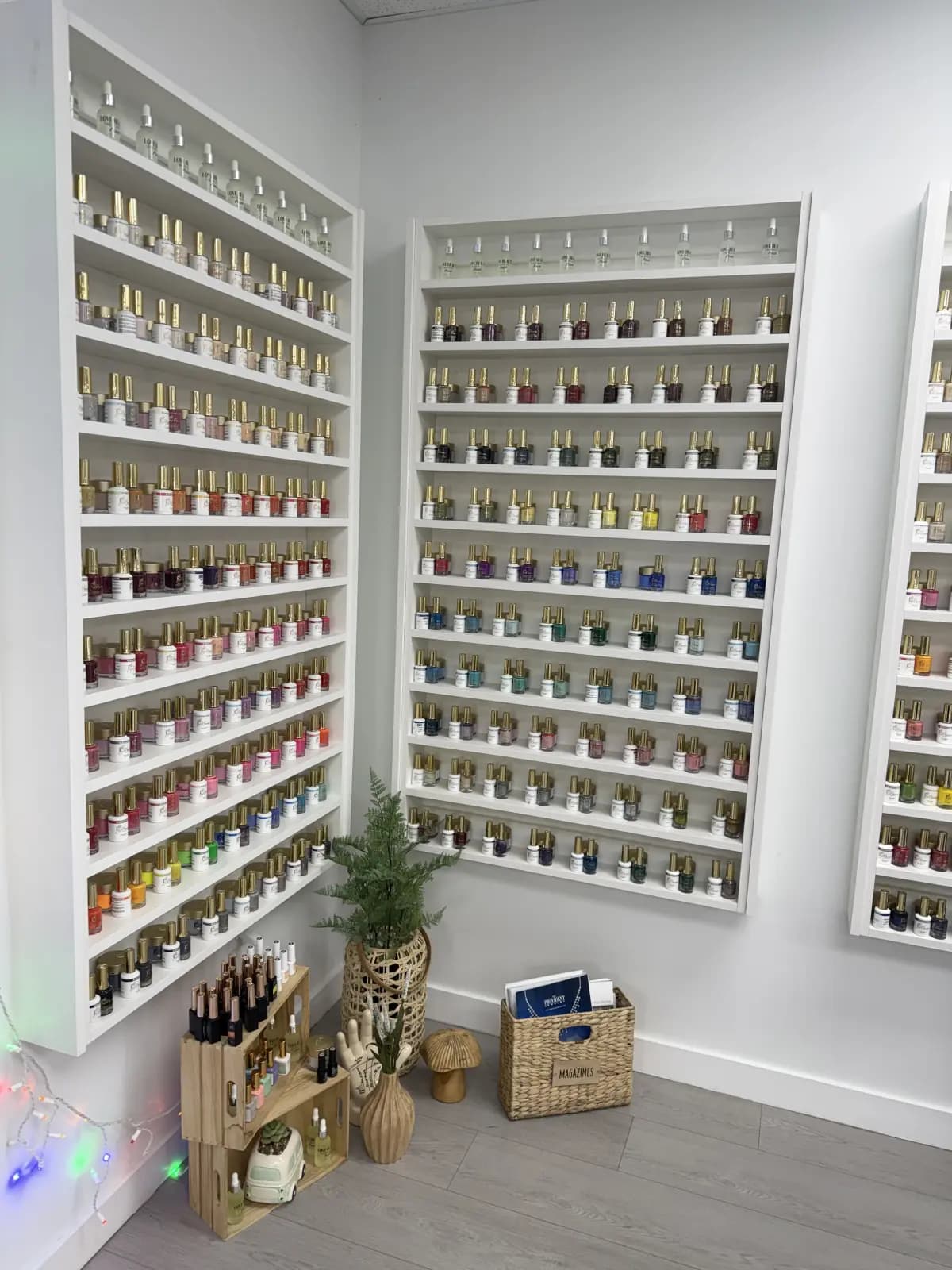 Polish wall at Live Love Beauty Salon in Hialeah: hundreds of gel colours arranged on white shelving