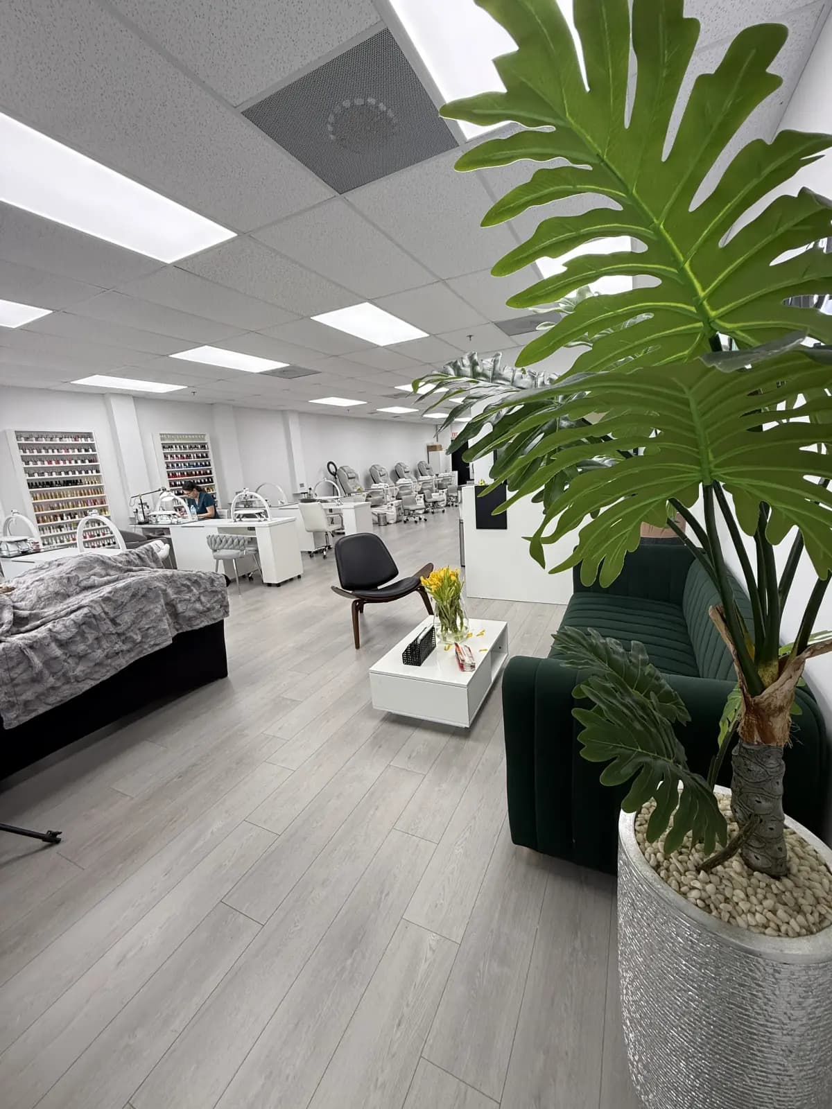 Main floor of the Hialeah salon with manicure stations, pedicure chairs, lash bed and polish walls